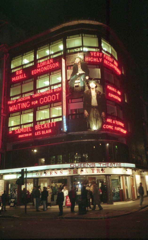 The Queens Theatre lit up at night when Rik Mayall and Ade Edmondson were appearing in the play Waiting For Godot