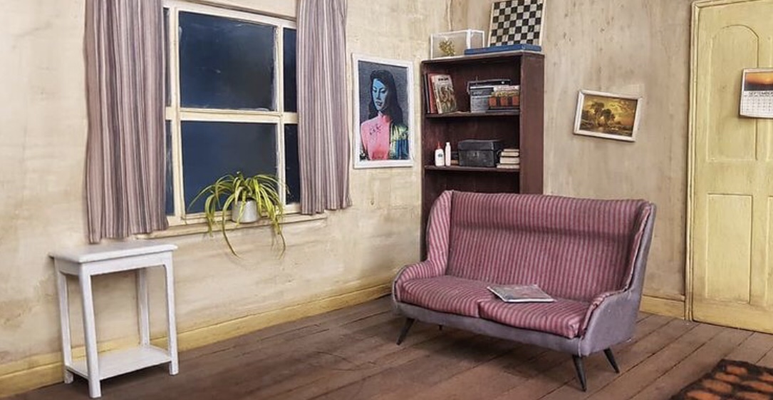 View of the lounge area complete with spider plant on the windowsill in the mini Bottom flat